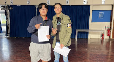 Two students holding results