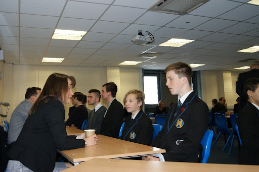 Students are seen interacting with representatives from different companies during a Careers Event at Hayesbrook Academy.