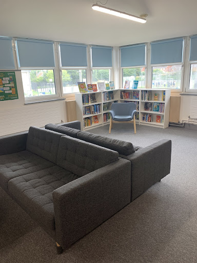 A photo of the Library with two back-to-back sofas in the centre of the room.