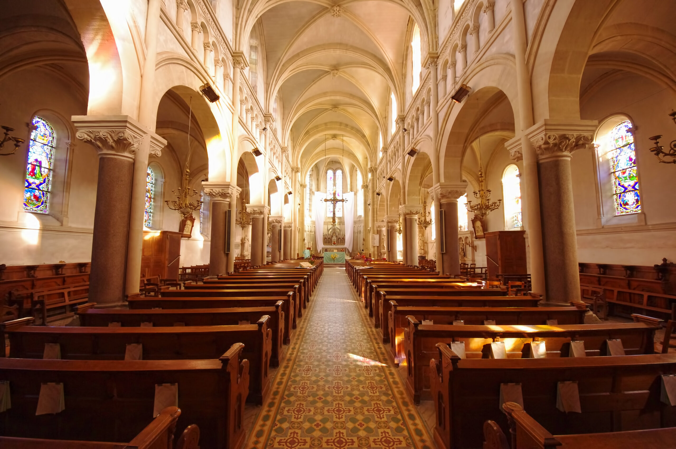 Inside view of a large, empty Church, taken from the back of the main room area, looking towards the front.